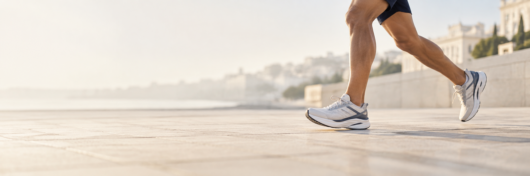 Runner’s lower legs and shoes in motion on a sunlit path